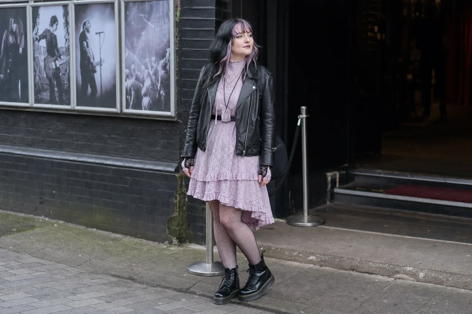 Realistic editorial lifestyle scene illustrating pastel goth fashion: balancing soft color and dark detail
