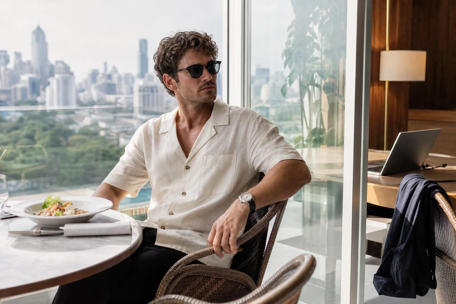 Realistic editorial lifestyle scene illustrating men's summer fashion: a cool, repeatable wardrobe plan